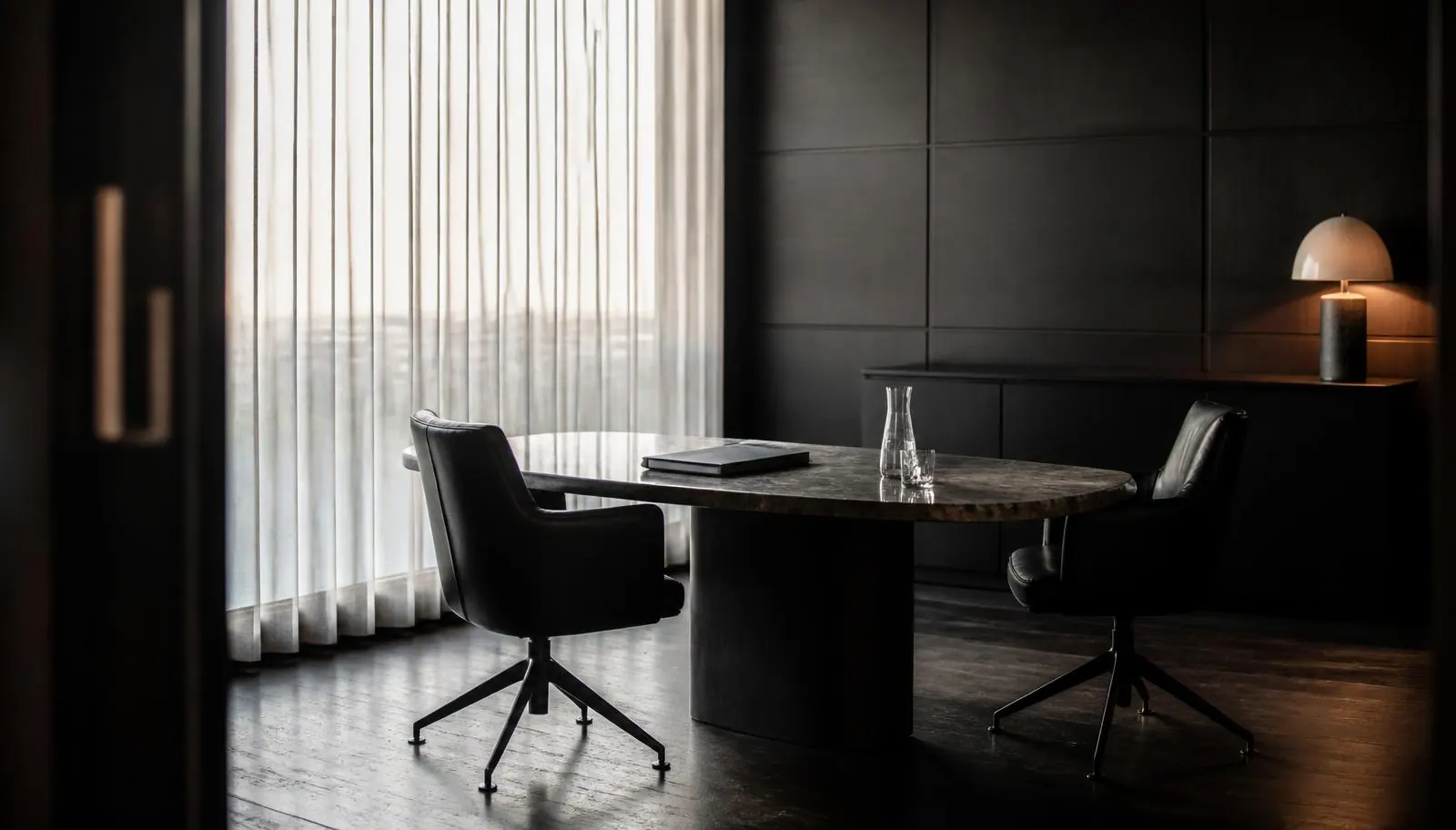 Private consultation office with leather chairs and a dark table set for a cannabis accounting meeting in Albuquerque